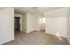 A bedroom with dormer windows, neutral walls and carpet, and an open door at 380 Oak Landing Cir, Douglasville, GA 30134