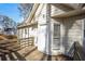 Exterior view of a home's back entrance with a wooden deck and white siding at 380 Oak Landing Cir, Douglasville, GA 30134