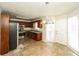 Well-lit eat-in kitchen featuring stainless steel appliances, wood cabinets, and tile flooring at 380 Oak Landing Cir, Douglasville, GA 30134