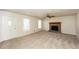 Spacious living room with neutral carpet, ceiling fan, and stone fireplace for a warm and inviting atmosphere at 380 Oak Landing Cir, Douglasville, GA 30134