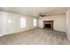 Inviting living room showcasing a stone fireplace, natural light, and neutral carpet, enhancing comfort at 380 Oak Landing Cir, Douglasville, GA 30134