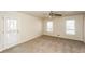 Bright living room with neutral tones, carpeted flooring, and natural light from windows and door at 380 Oak Landing Cir, Douglasville, GA 30134