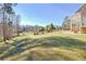 Landscaped backyard with mature trees, offering privacy and tranquility at 4320 Chapel Hill Farms Dr, Douglasville, GA 30135