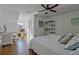 Bedroom with hardwood floors, built-in shelves, and home office area at 4320 Chapel Hill Farms Dr, Douglasville, GA 30135