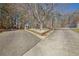Long driveway with a central garden bed and a gazebo in the background at 4320 Chapel Hill Farms Dr, Douglasville, GA 30135