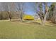 House nestled amongst mature trees and a spacious green lawn at 4320 Chapel Hill Farms Dr, Douglasville, GA 30135