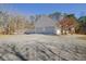 Two-car garage with ample driveway space and wooded backdrop at 4320 Chapel Hill Farms Dr, Douglasville, GA 30135