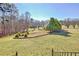 Expansive landscaped yard with manicured lawn and tree lined borders at 4320 Chapel Hill Farms Dr, Douglasville, GA 30135