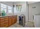 Bright laundry room with built-in cabinets and wine cooler at 4320 Chapel Hill Farms Dr, Douglasville, GA 30135