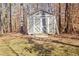 Grey storage shed with white accents in wooded area at 4320 Chapel Hill Farms Dr, Douglasville, GA 30135