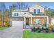 Two-story house with stone and white siding, a large front porch, and a two-car garage at 3686 Bills Cir, Atlanta, GA 30331