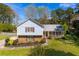 Ranch style home with brick and siding, covered porch, and landscaped yard at 553 Wellington Way, Jonesboro, GA 30238