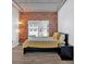 Spacious bedroom with exposed brick wall and large window at 800 Peachtree Ne St # 2405, Atlanta, GA 30308