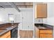 Modern kitchen with black appliances and light wood cabinets at 800 Peachtree Ne St # 2405, Atlanta, GA 30308