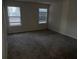 Bedroom features windows and neutral carpet at 132 Oliver Dr, Locust Grove, GA 30248