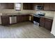 Modern kitchen featuring dark wood cabinets and stainless steel appliances at 132 Oliver Dr, Locust Grove, GA 30248