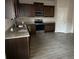 Modern kitchen with dark wood cabinets, granite counters, and stainless steel appliances at 132 Oliver Dr, Locust Grove, GA 30248