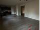 Open concept living room with wood-look floors and a view of the kitchen at 132 Oliver Dr, Locust Grove, GA 30248