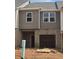 Exterior view of home with gray siding and brick, and attached garage awaiting completion at 2812 Lillian Ln, Douglasville, GA 30135