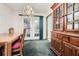 Dining room with wooden table and chairs, hutch, and access to backyard at 6685 Smoke Ridge Dr, Atlanta, GA 30349