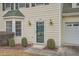 Attractive front door with glass panels and sidelights, flanked by bushes at 6685 Smoke Ridge Dr, Atlanta, GA 30349