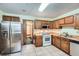 Kitchen features stainless steel refrigerator and wood cabinets at 6685 Smoke Ridge Dr, Atlanta, GA 30349