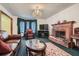 Living room featuring a brick fireplace, leather furniture, and a chandelier at 6685 Smoke Ridge Dr, Atlanta, GA 30349