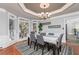 Bright dining room with hardwood floors, coffered ceiling, and large windows at 2688 Moon Cabin Dr, Powder Springs, GA 30127