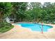 Inviting kidney shaped pool with surrounding landscaping at 2688 Moon Cabin Dr, Powder Springs, GA 30127