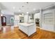 Open concept kitchen with white cabinetry, island, and fireplace at 396 15Th Street Nw # 95, Atlanta, GA 30318