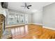 Spacious living room with hardwood floors, fireplace, and ceiling fan at 396 15Th Street Nw # 95, Atlanta, GA 30318