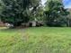 Large grassy yard with scattered trees and a partially obscured view of the house at 4402 Highland Rd, Decatur, GA 30035