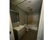 Modest bathroom featuring a combined bathtub and shower, sink, and wooden-framed mirror at 4402 Highland Rd, Decatur, GA 30035