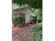 View of the side of the house with flower bed, greenery, and covered porch at 4402 Highland Rd, Decatur, GA 30035