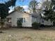 Tan vinyl-sided house with front porch and yard at 4402 Highland Rd, Decatur, GA 30035