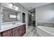 Spa-like bathroom featuring a soaking tub and walk-in shower at 490 La Perla Dr, Sugar Hill, GA 30518
