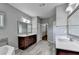 Bathroom with double vanity and access to walk-in closet at 490 La Perla Dr, Sugar Hill, GA 30518