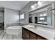 Elegant bathroom with double vanity and large mirror at 490 La Perla Dr, Sugar Hill, GA 30518