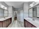 Double vanity bathroom with grey tile floors and a walk-in closet at 490 La Perla Dr, Sugar Hill, GA 30518