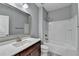 Bathroom with tub shower, vanity, and wood-look flooring at 490 La Perla Dr, Sugar Hill, GA 30518