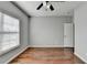 Well-lit bedroom with hardwood floors and a door at 490 La Perla Dr, Sugar Hill, GA 30518