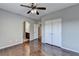 Bedroom with hardwood floors, ceiling fan and walk-in closet at 490 La Perla Dr, Sugar Hill, GA 30518