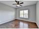 Spacious bedroom with hardwood floors and ceiling fan at 490 La Perla Dr, Sugar Hill, GA 30518