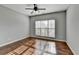 Bright bedroom with hardwood floors and ceiling fan at 490 La Perla Dr, Sugar Hill, GA 30518