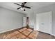 Bedroom with hardwood floors, double doors, and ceiling fan at 490 La Perla Dr, Sugar Hill, GA 30518