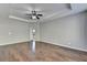 Spacious bedroom with hardwood floors and ceiling fan at 490 La Perla Dr, Sugar Hill, GA 30518