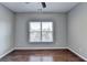 Bright bedroom featuring hardwood floors and large window at 490 La Perla Dr, Sugar Hill, GA 30518
