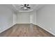 Bright bedroom featuring hardwood floors and double doors at 490 La Perla Dr, Sugar Hill, GA 30518