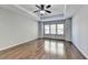 Primary bedroom with hardwood floors, tray ceiling, and ceiling fan at 490 La Perla Dr, Sugar Hill, GA 30518