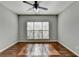 Spacious bedroom with hardwood floors and large window at 490 La Perla Dr, Sugar Hill, GA 30518